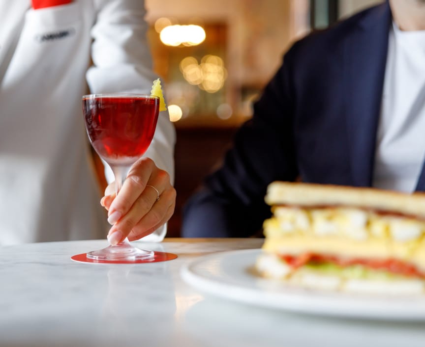 waitor serving a cocktail at Camparino